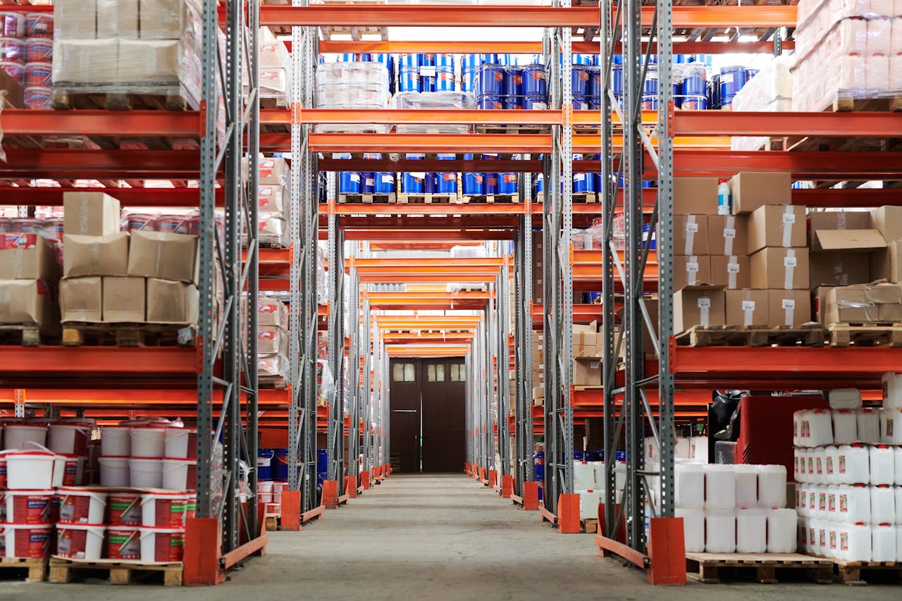 hero-img-02 Wide angle view of a warehouse with stocked shelves and boxes.