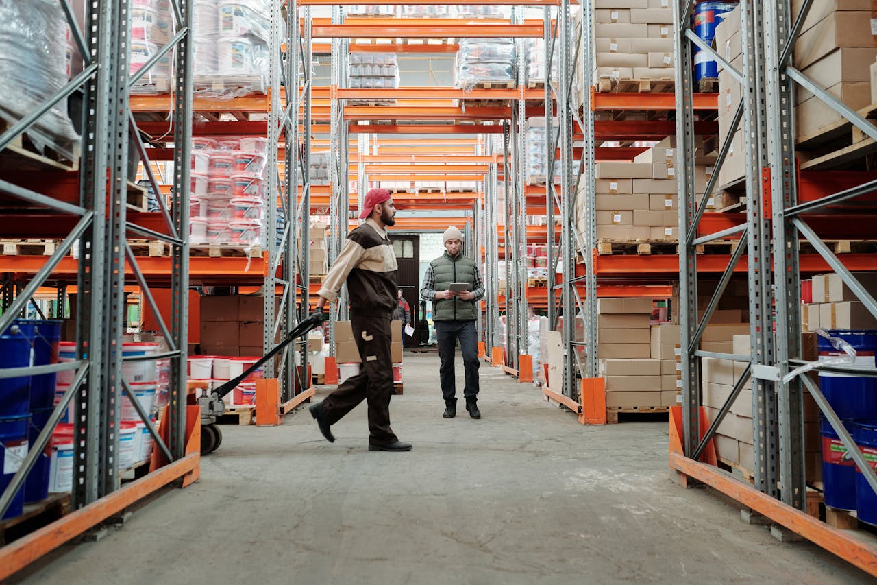The Art of Drawing Readers In: Your attractive post title goes here Two workers manage inventory in a spacious warehouse aisle.